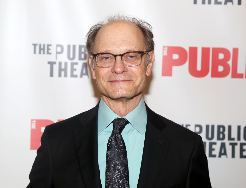 Frasier star David Hyde Pierce in a black suit jacket and light blue/green shirt