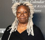 Whoopi Goldberg with blond dreadlocks wearing a black dress