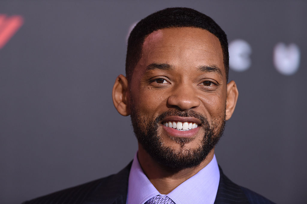 Will Smith smiling in a lilac shirt and black jacket