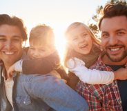 A gay male couple representing same-sex couples who have a child through an adoption agency