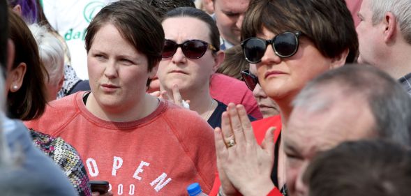 Sara Canning (L), partner of killed journalist Lyra McKee, stands beside Democratic Unionist Party (DUP) leader Arlene Foster (R) at a gathering to condemn McKee's killing near the scene of rioting violence in the Creggan area of Derry in Northern Ireland