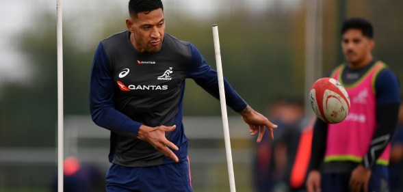 Israel Folau of Australia offloads during a training session.