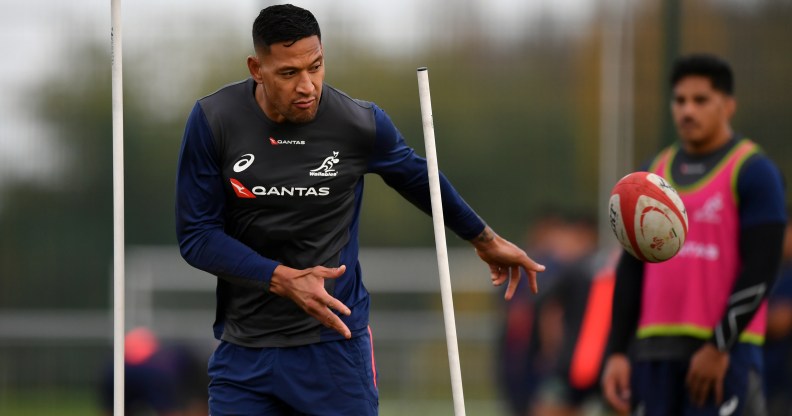 Israel Folau of Australia offloads during a training session.