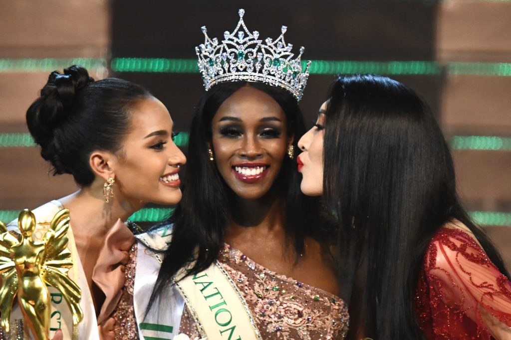 Jazell Barbie Royale (C) of the US, the Miss International Queen 2019 receives a kiss from finalists Kanwara Kaewjin (L) of Thailand and Yaya (R) of China