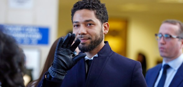 Actor Jussie Smollett waves as he follows his attorney to the microphones after his court appearance at Leighton Courthouse on March 26, 2019 in Chicago, Illinois.