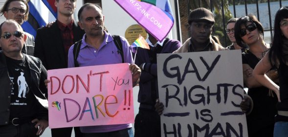 A group of people from the gay, lesbian and transgender community in South Africa demonstrate outside the Parliament in Cape Town, on May 19, 2012. The protesters gathered to oppose the proposal by the House of Traditional Leaders to remove the term "sexual orientation" from section 9 (3) of the South African Constitution, which prohibits unfair discrimination. AFP PHOTO / RODGER BOSCH (Photo credit should read RODGER BOSCH/AFP/GettyImages)