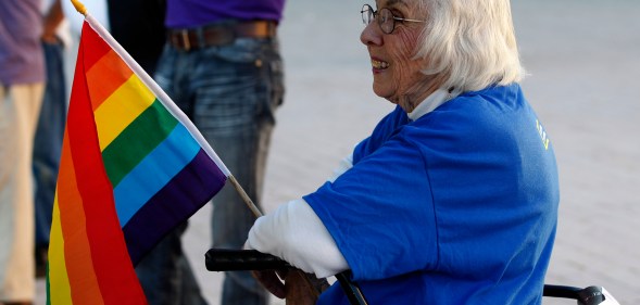 Older LGBT people like this woman holding a gay pride flag at a same-sex marriage victory celebration remain to be met.