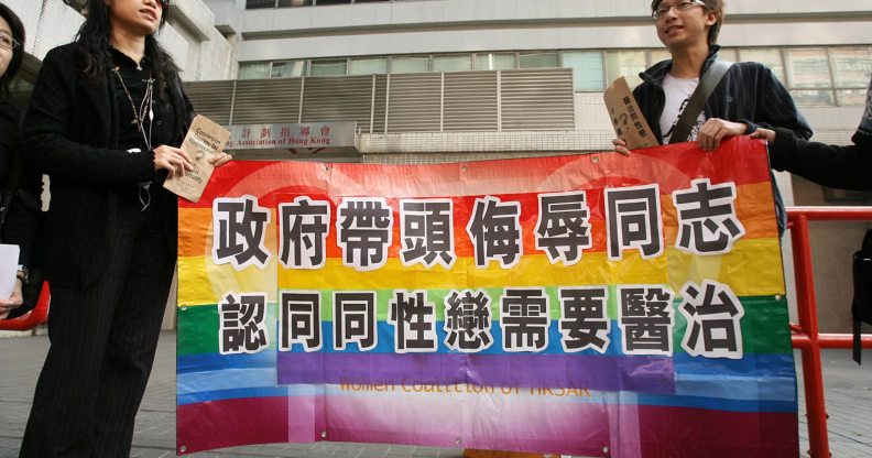 Hong Kong, CHINA: A gay and homosexual group lead a protest to government offices in Hong Kong 01 December 2006. The group were urging the government to end discrimination to homosexuals with regard to an organisation which promotes conversion therapy for homosexuals. Banner reads" Government leads campaign to insult gays and believes they need a cure" AFP PHOTO/MIKE CLARKE (Photo credit should read MIKE CLARKE/AFP/Getty Images)