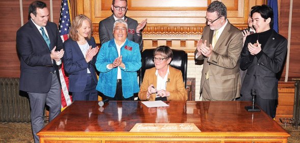 Governor of Kansas Laura Kelly signs an executive order protecting LGBT+ state employees from discrimination