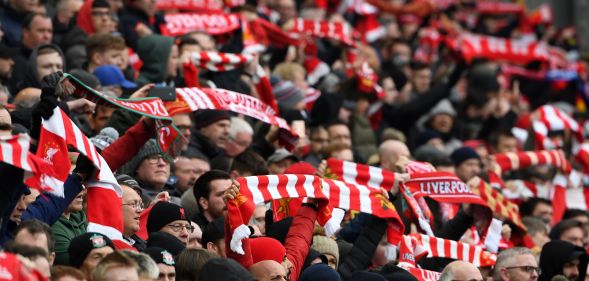 Liverpool supporters hold up their scarves in the crowd ahead of the English Premier League football match between Liverpool and Chelsea at Anfield in Liverpool, north west England on April 14, 2019.