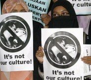 Malaysian Muslim students hold placards during a protest against the US glam rocker Adam Lambert's concert in Bukit Jalil, outside Kuala Lumpur, on October 14, 2010.