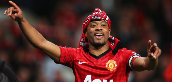 Patrice Evra of Manchester United celebrates victory and winning the Premier League title after the Barclays Premier League match between Manchester United and Aston Villa at Old Trafford on April 22, 2013 in Manchester, England.