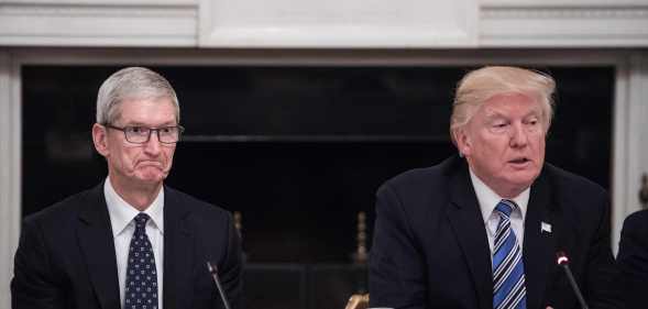 Apple CEO Tim Cook (L) listens to US President Donald Trump during an American Technology Council roundtable at the White House in Washington, DC, on June 19, 2017.