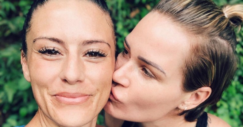 American Women's World Cup-winning footballers Ashlyn Harris and Ali Krieger embrace.