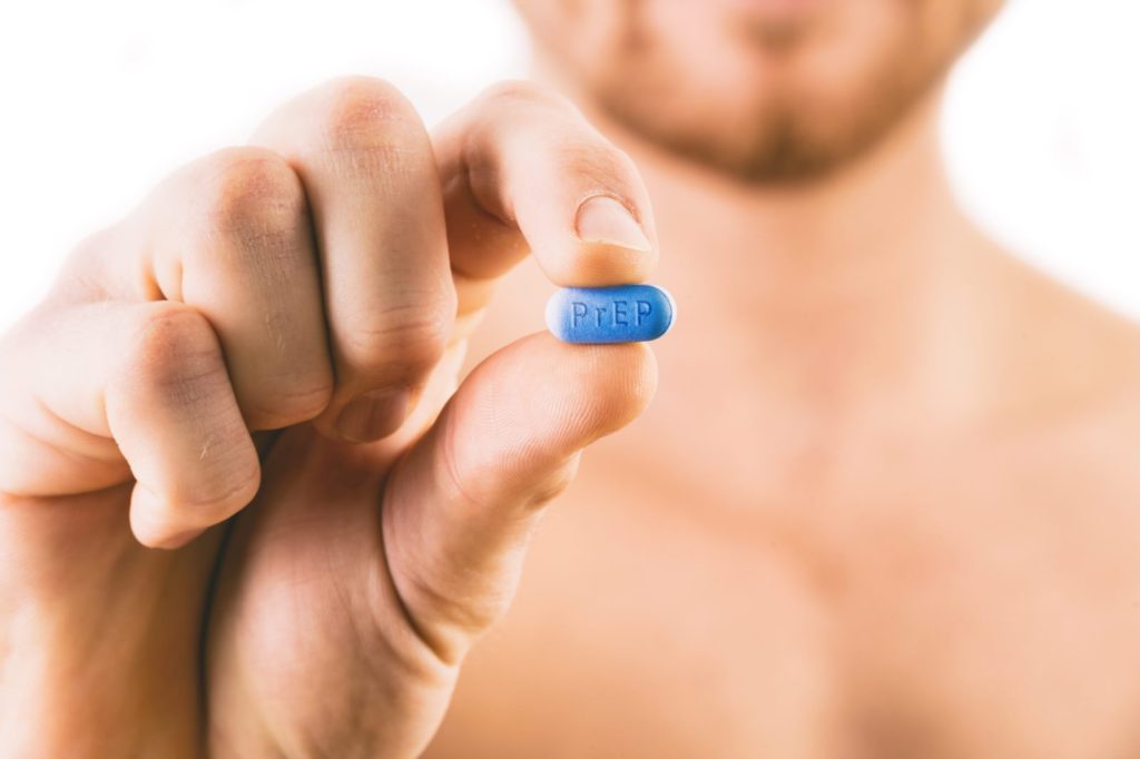 PrEP Impact trial: Man holding a pill used for Pre-Exposure Prophylaxis (PrEP) to prevent HIV infection