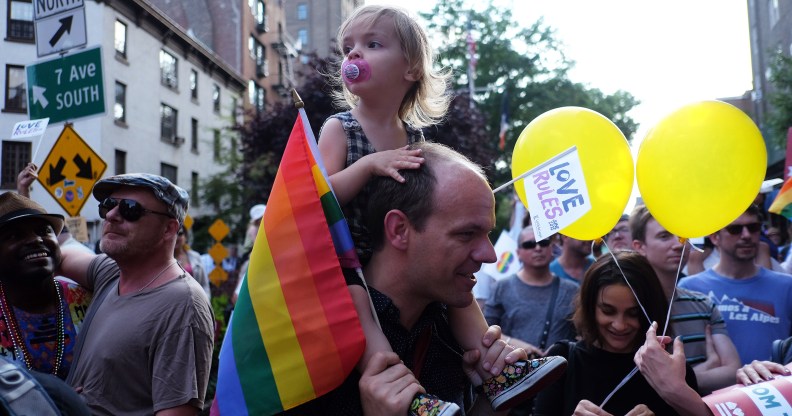 A dad and child, representing two thirds of gay dads saying they face stigma in a new survey