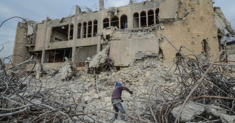 ISIS news: An Iraqi climbs up the rubble of the destroyed seven-storey Chadirji Building, designed by celebrated Iraqi architect Rifat Chadirji in the 1960s, on January 13, 2019, in the city of Mosul.