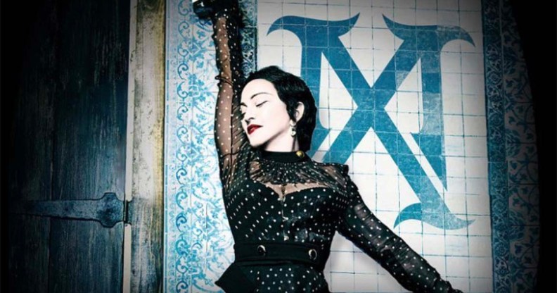 Madonna as Madame X, standing against a wall