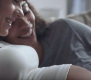 A lesbian biracial couple look at their baby on a Samsung phone in a Samsung advert