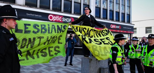 Women holding banners at Swansea Pride