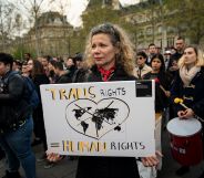 A woman holding a sign which reads "trans rights are human rights"