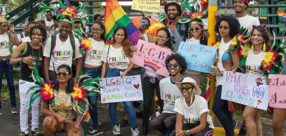 LGBT+ right activists at Guyana Pride holding up signs