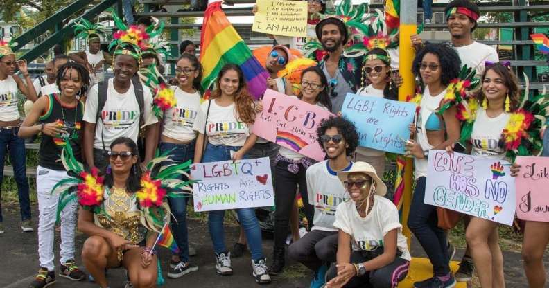 LGBT+ right activists at Guyana Pride holding up signs