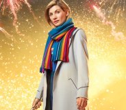 Jodie Whittaker as the Doctor in Doctor Who, wearing a rainbow scarf