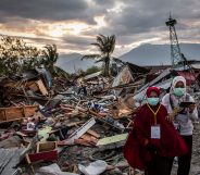 PALU, INDONESIA - OCTOBER 05: People walk along a damaged area which was hit by liquefaction in Petobo village following the earthquake on October 5, 2018 in Palu, Central Sulawesi, Indonesia. The death toll from last weeks earthquake and tsunami has risen to at least 1,558 but widely expected to rise as officials said on Friday the number of victims of the liquefaction could be up to a thousand. Power had returned to parts of the city and fuel shipments have begun to flow back but some affected towns remain inaccessible with the infrastructure badly damaged. A tsunami triggered by a magnitude 7.5 earthquake slammed into Indonesia's coastline on the island of Sulawesi which destroyed or damaged over 70,000 homes as tensions remain high with desperate survivors trying to secure basics like clean water and fuel for generators. (Photo by Ulet Ifansasti/Getty Images)