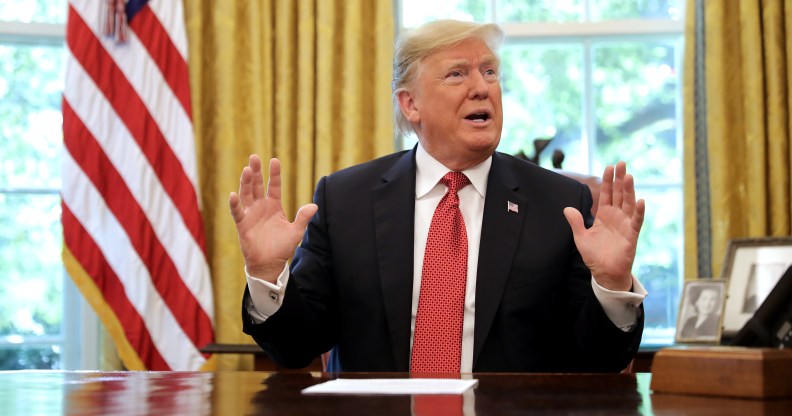 WASHINGTON, DC - OCTOBER 17: U.S. President Donald Trump talks to reporters while hosting workers and members of his cabinet for a meeting in the Oval Office at the White House October 17, 2018 in Washington, DC. The White House said the meeting was on “Cutting the Red Tape, Unleashing Economic Freedom." (Photo by Chip Somodevilla/Getty Images)