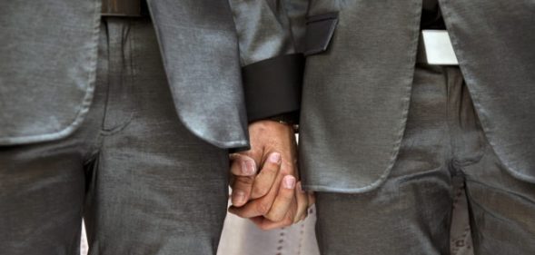 Two men holding hands