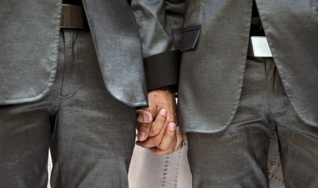 Two men holding hands