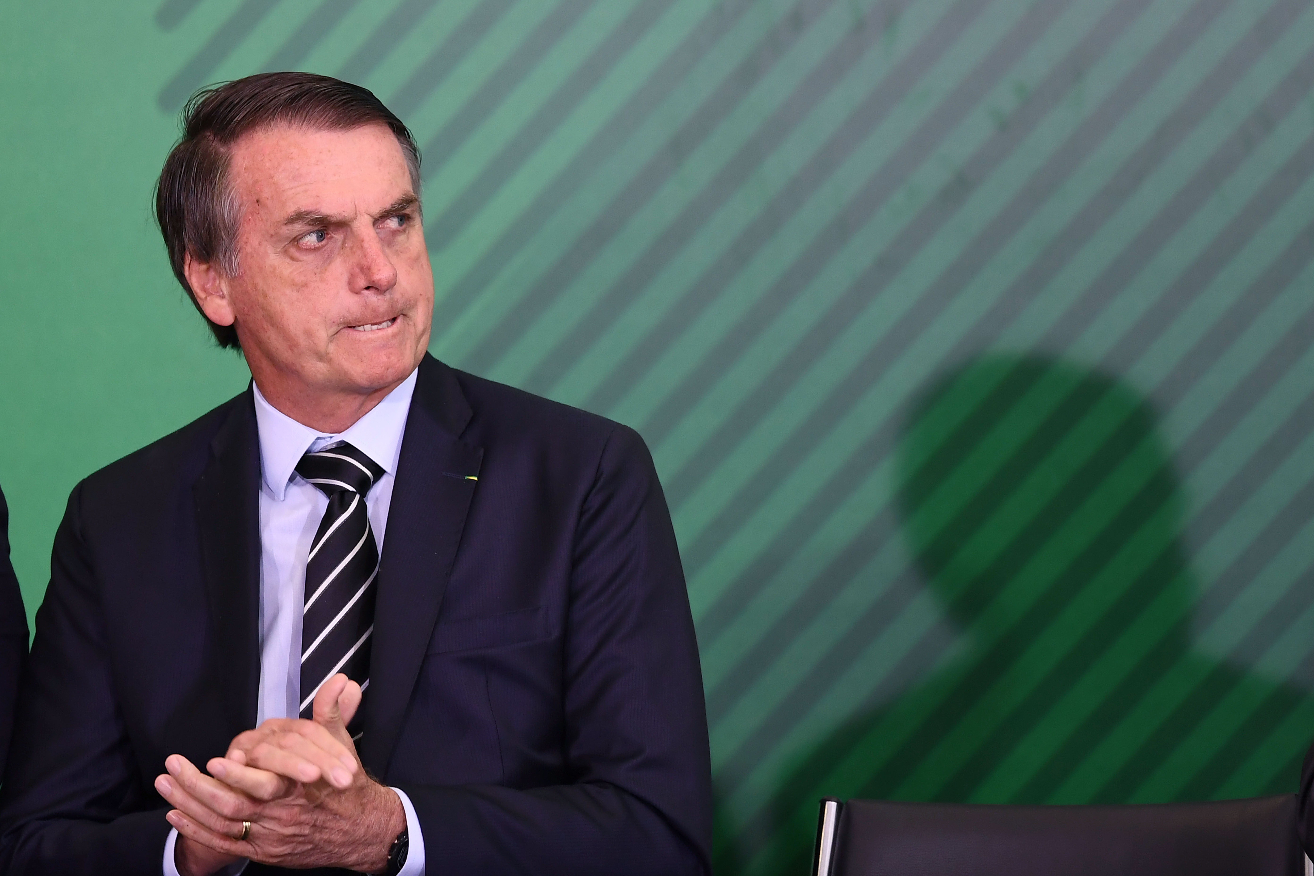 Brazilian President Jair Bolsonaro, whose elections has worried LGBT rights activists, gestures during a ceremony.