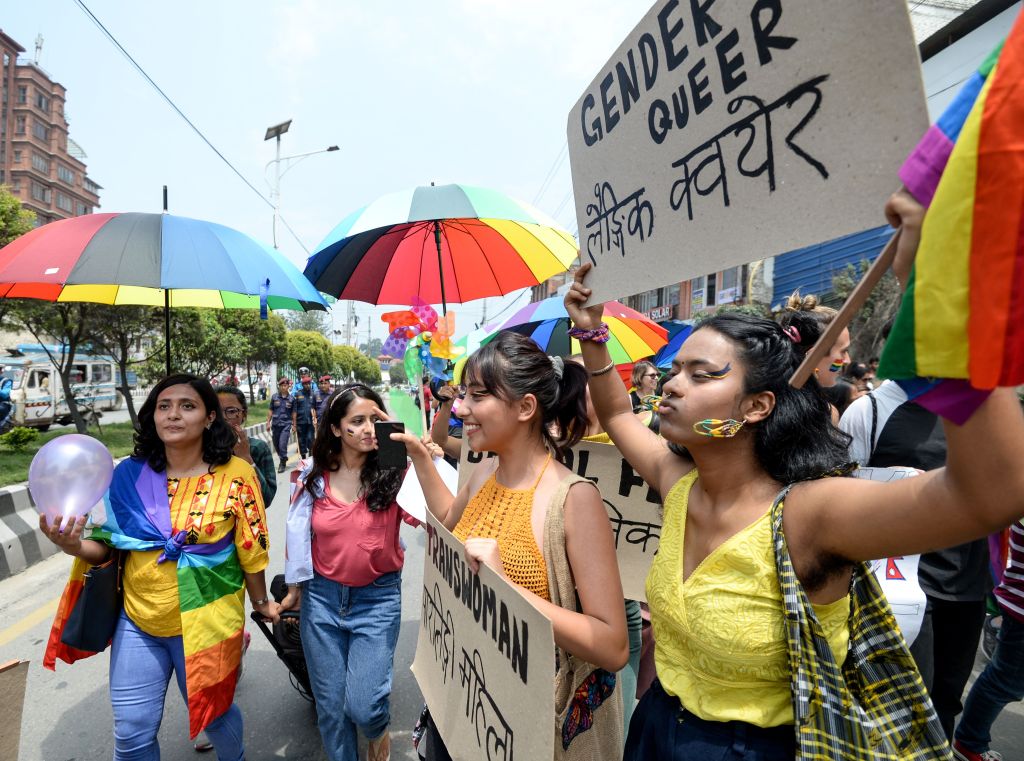 Members of Nepal's LGBT+ community hold placards as they take part in a Pride Parade in Kathmandu on June 29, 2019