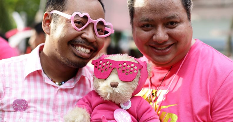 SINGAPORE - JUNE 30: Participants dress in various shades of pink pose for a photo during the 'Night Pink Dot' event arrange to increase awareness and understanding of the lesbian, gay, bisexual and transgender community in Singapore at Hong Lim Park on June 30, 2012 in Singapore. The event is the fourth annual gathering held in support of the freedom to love. (Photo by Suhaimi Abdullah/Getty Images)
