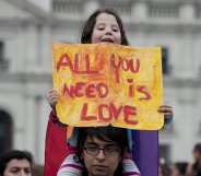 Man with daughter on shoulders protest for LGBT right