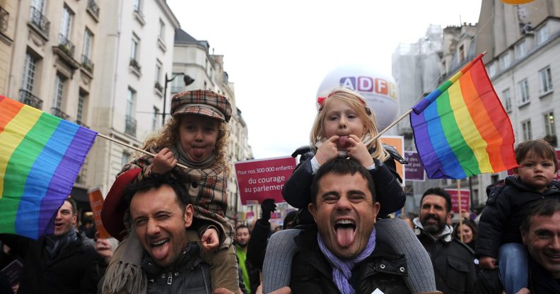 PARIS, FRANCE - DECEMBER 16: People demonstrate for the legalisation of gay marriage and parenting on December 16, 2012 in Paris, France. Demonstrations have shown a deep division in French society over the marriage equality bill expected to be passed in early 2013. The bill would not only legalize same-sex marriage but would also allow gay couples to adopt, which is seen as the most controversial issue. French President Francois Hollande, who has supported the legislation, is facing criticism from anti-gay and religious groups, while gay rights groups have warned of inadequacies within the bill. (Photo by Antoine Antoniol/Getty Images)