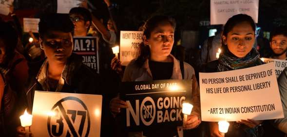 Indian LGBT activists hold placards as they demonstrate against the Supreme Court's reinstatement of Section 377, which bans gay sex in a law dating from India's colonial era, in Bangalore on January 28, 2014. India's top court January 28 rejected a plea filed by the government and activist groups to review its shock ruling which reinstated a colonial-era ban on gay sex. AFP PHOTO/Manjunath KIRAN (Photo credit should read Manjunath Kiran/AFP/Getty Images)