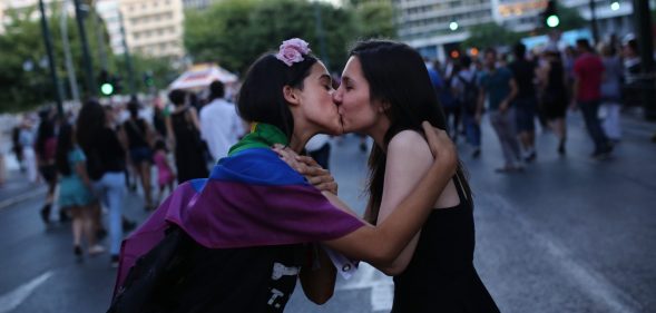 two womn kiss as they take part in the annual Gay Pride parade in Athens, on June 13, 2015. Greece's radical-left government on June 10, 2015, proposed a bill to grant same-sex couples the right to a civil union, two years after the European Court of Human Rights condemned the country's existing legislation as discriminatory. AFP PHOTO / ANGELOS TZORTZINIS (Photo credit should read ANGELOS TZORTZINIS/AFP/Getty Images)