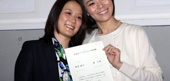 Japanese lesbian couple Hiroko Masuhara (L) and Koyuki Higashi display a certification paper of "partnership" after receiving it at the Shibuya ward office in Tokyo on November 5, 2015. While the certificates are not legally binding, the district hoped they would encourage hospitals and landlords to ensure same-sex couples receive similar treatment to married people. AFP PHOTO / Yoshikazu TSUNO (Photo credit should read YOSHIKAZU TSUNO/AFP/Getty Images)