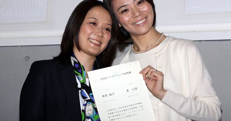 Japanese lesbian couple Hiroko Masuhara (L) and Koyuki Higashi display a certification paper of "partnership" after receiving it at the Shibuya ward office in Tokyo on November 5, 2015. While the certificates are not legally binding, the district hoped they would encourage hospitals and landlords to ensure same-sex couples receive similar treatment to married people. AFP PHOTO / Yoshikazu TSUNO (Photo credit should read YOSHIKAZU TSUNO/AFP/Getty Images)