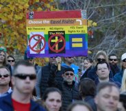 SALT LAKE CITY, UT - NOVEMBER14: A man holds a protest sign in City Creek Park after many submitted their resignations from the Church of Jesus Christ of Latter-Day Saints in response to a recent change in church policy towards married LGBT same sex couples and their children on November 14, 2015 in Salt Lake City, Utah. A little over a week ago the Mormon church made a change in their official handbook of instructions requiring a disciplinary council and possible excommunication for same sex couples and banning the blessing and baptism of their children into the church. (Photo by George Frey/Getty Images)