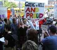 SEATTLE - MAY 1: Protestors hold signs and greet participants to a rally to affirm traditional marriage between a man and a woman on May 1, 2004 at Safeco Field in Seattle. The special speaker was James Dobson, founder of the evangelical Christian group called "Focus on the Family". The event was organized by local Christian groups and drew approximately 20,000 people as well as about 3,000 protestors, according to police. (Photo by Ron Wurzer/Getty Images)