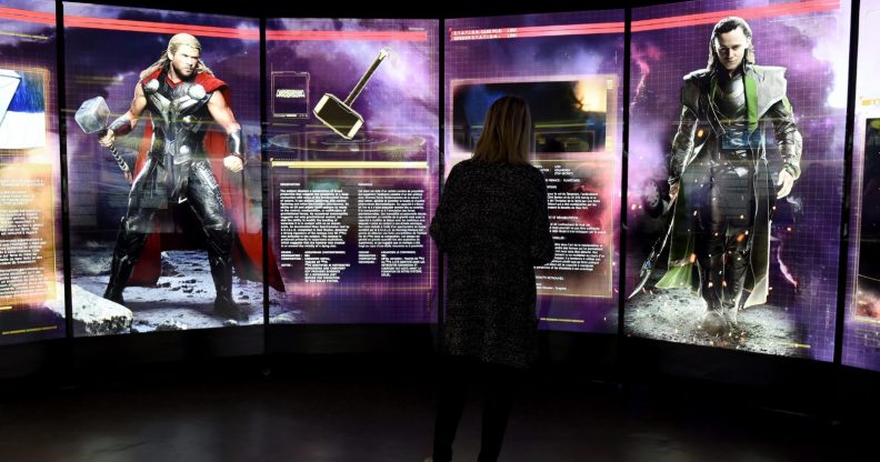 A visitor looks at a display on Marvel Comics superhero "Thor" (L) and character "Loki" at the interactive Marvel Avengers STATION exhibition in the bussines district of La Defense, west of Paris, on April 13, 2016. / AFP / MIGUEL MEDINA / RESTRICTED TO EDITORIAL USE - MANDATORY MENTION OF THE ARTIST UPON PUBLICATION - TO ILLUSTRATE THE EVENT AS SPECIFIED IN THE CAPTION (Photo credit should read MIGUEL MEDINA/AFP/Getty Images)