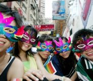 HONG KONG, CHINA: Gay activists wearing masks attend a gathering and march in the Causeway Bay district of Hong Kong, 16 May 2005. Some 350 people from various backgrounds gathered 16 May to raise public awareness for the first time on homophobia and promote diversity. AFP PHOTO/TED ALJIBE (Photo credit should read TED ALJIBE/AFP/Getty Images)