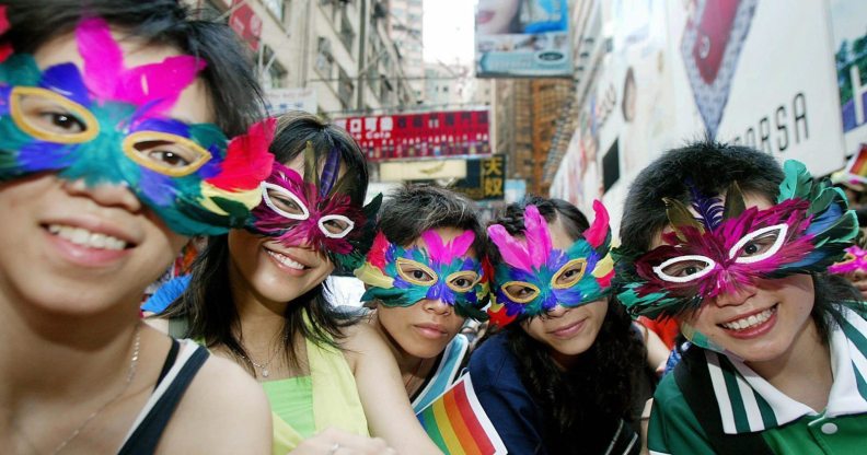 HONG KONG, CHINA: Gay activists wearing masks attend a gathering and march in the Causeway Bay district of Hong Kong, 16 May 2005. Some 350 people from various backgrounds gathered 16 May to raise public awareness for the first time on homophobia and promote diversity. AFP PHOTO/TED ALJIBE (Photo credit should read TED ALJIBE/AFP/Getty Images)