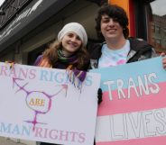 Protesters holding up pro trans signs