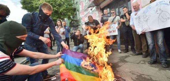 Far-right activists burn the LGBT flag during the official opening of Kyiv Pride 2017