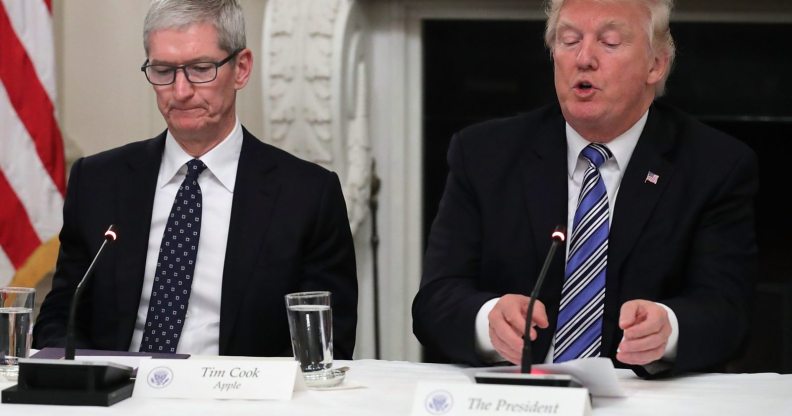 WASHINGTON, DC - JUNE 19: Apple CEO Tim Cook listens to U.S. President Donald Trump deliver opening remarks during a meeting of the American Technology Council in the State Dining Room of the White House June 19, 2017 in Washington, DC. According to the White House, the council's goal is "to explore how to transform and modernize government information technology." (Photo by Chip Somodevilla/Getty Images)