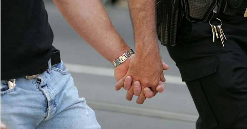 A same-sex couple holding hands, representing the gay couples who met online